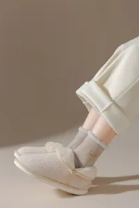 Detailed view of cozy thick fleece-lined winter socks and plush slippers for home warmth.