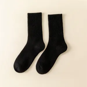 Detailed shot of black men's thermal wool socks featuring ribbed cuffs and thick loop soles.