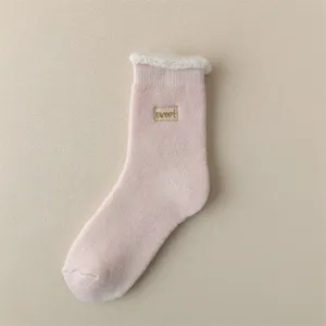 Close-up of pink winter thermal sock with cozy fleece cuff and sweet embroidery detail.