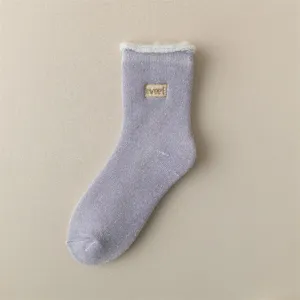 Plush lined thick winter crew sock detail view with sweet embroidery patch and fuzzy trim.