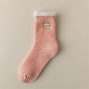 Cozy thick fleece-lined winter thermal socks for women, warm knit sleep socks in pink.