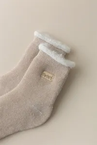Fleece-lined thick mid-calf winter warm socks detail, plush fuzzy cuff, cozy thermal floor wear.
