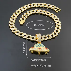 Detailed view of iced out Cuban link chain with crystal UFO pendant, hip hop jewelry.