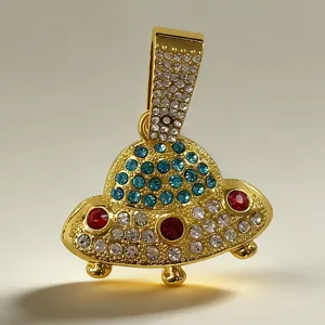 Detailed close-up shot of the gold UFO pendant, featuring sparkly rhinestones and hip-hop design.