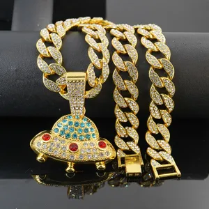 Detail shot of the rhinestone UFO pendant and Cuban chain necklace in hip hop style.