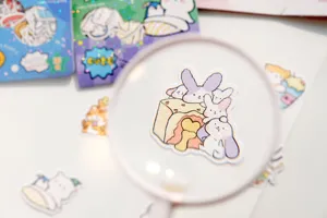 Close-up detail of cute cartoon bunny and cake sticker, featuring soft texture and fine printing.