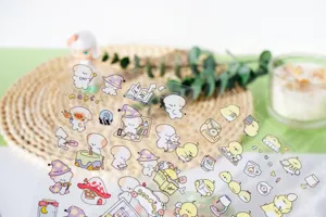 Detail view of cute waterproof PET transparent stickers with adorable cartoon dog and chick designs.