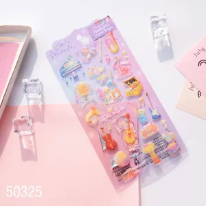 Close-up detail of colorful musical instrument epoxy stickers showcased on card setup in flat lay.