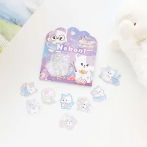 Detailed view of cute laser cat stickers set with card packaging on white table surface.