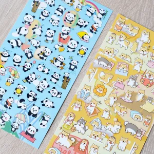 Close-up detail shot of cute cartoon panda and shiba inu sticker sheets, perfect for journaling.