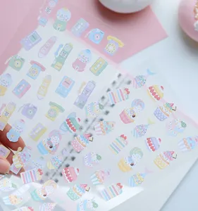 Detailed view of sweet macaron illustration sticker sheets, cute aesthetic journal stationery.