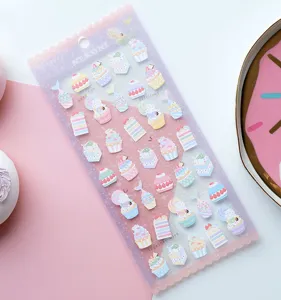 Detailed close-up view of sweet pink macaron dessert stickers for journal decoration.