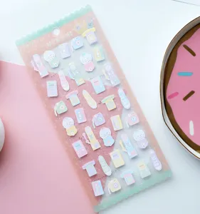 Detail shot of pastel retro planner stickers with cute gadget designs in clear packaging.