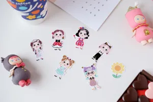 Cute freckled cartoon girl decorative journaling stickers detail view in creative flatlay setup