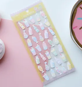 Detailed view of dreamy macaron style decorative sticker sheet with cute milk bottle designs.