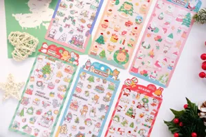 Detailed view of cute Christmas PVC laser glitter stickers featuring bears, cats, and rabbits.