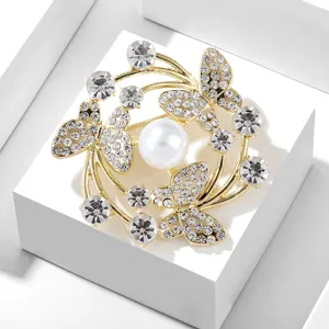 Exquisite butterfly pearl brooch detail, sparkling rhinestones, elegant gold suit accessory.