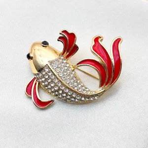 Exquisite red enamel and rhinestone gold-tone koi fish brooch detail view for apparel decor.