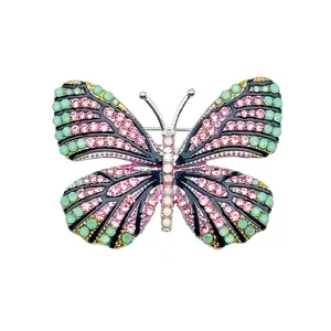 Close-up detail view of the colorful crystal butterfly brooch, rhinestone inlay texture.