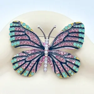 Detailed close-up shot of an exquisite butterfly brooch featuring vibrant rhinestones.