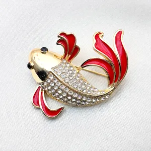 Close-up detail of a stunning gold-tone koi fish brooch with red enamel fins and sparkling rhinestones.