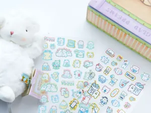 Close-up detail of cute aesthetic transparent journaling stickers with adorable cartoon animals.
