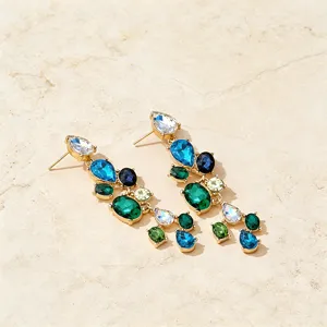 Detail view of colorful crystal teardrop dangle earrings with vintage rhinestone cluster design.