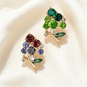 Detailed view of sparkling rhinestone grape brooch with colorful crystals and enamel leaves.