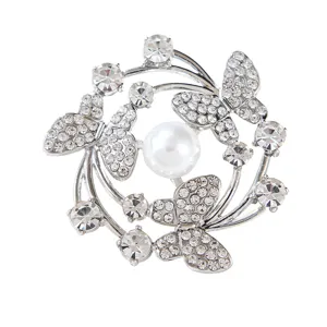 Elegant silver tone butterfly brooch featuring sparkling rhinestones and a central white pearl accessory.