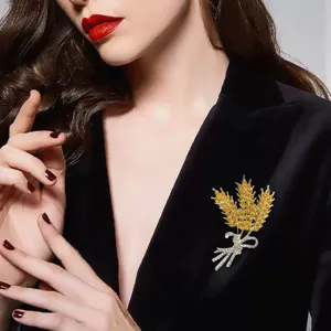 Exquisite gold wheat ear brooch featuring sparkling rhinestone bow, ideal for jackets.