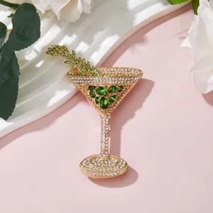 Exquisite rhinestone cocktail glass brooch detail, sparkling green gems, elegant fashion jewelry.