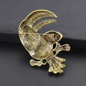 Vintage gold tone alloy toucan bird brooch pin back detail shot showcasing metal clasp and texture.