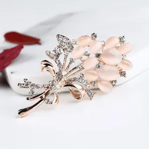 Detail shot of a rose gold cat's eye rhinestone tulip brooch, exquisite floral jewelry.