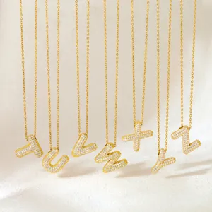 Detailed view of gold-plated micro-paved cubic zirconia puffy letter pendant necklaces.