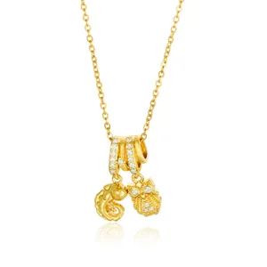 Elegant gold-tone layered ring pendant necklace with sparkling crystal owl and spiral charms.