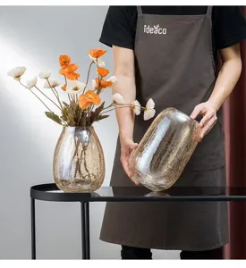 Large glass cracked texture vase for flower arrangement and elegant home decor detail view.