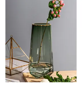 Nordic minimalist faceted green glass vase detail view, elegant transparent flower container for home.