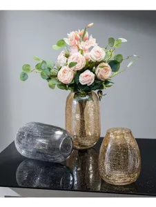 Crackle glass vase detail showing sparkling texture and elegant floral arrangement craftsmanship.