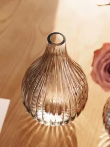 Nordic glass vase detail view, amber ribbed decorative flower container for modern home decor.