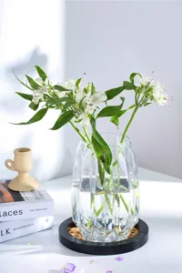 Clear glass vase closeup featuring vertical ribbed texture and elegant modern design aesthetic.