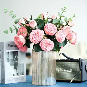 European style glass vase with artificial pink roses and eucalyptus leaves for home decor.