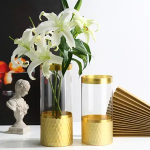 Modern transparent glass vase set with gold rim and white lilies for home decoration