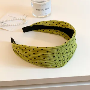 Green pleated polka dot headband detail view, wide hair hoop for women's daily styling accessories.