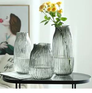 Transparent grey ribbed glass vase set for home decor, modern flower arrangement centerpiece.