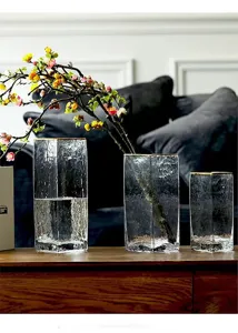 Clear textured glass vase detail showing elegant gold rim and transparent square design.