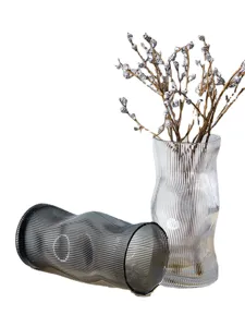 Modern striped glass vase set for home decor, unique curved transparent flower arrangement.