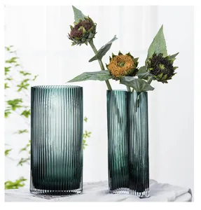 Dark green ribbed glass vase detail, creative geometric shape for interior floral decor.