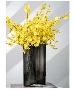 Nordic creative footprint geometric glass vase with yellow artificial orchids for home decor.