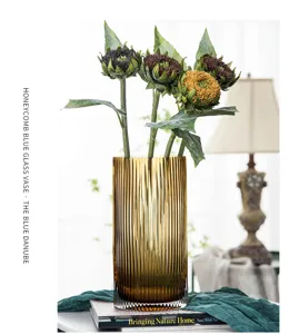 Nordic ribbed amber glass vase detail shot showing elegant cylindrical design and texture.
