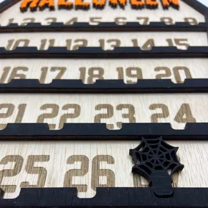 Close-up detail of wooden Halloween advent calendar with engraved numbers and spider web